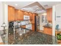 Modern kitchen with granite countertops and stainless steel appliances at 340 Three Lakes Ln # K, Venice, FL 34285
