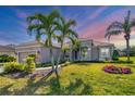 Lovely single-Gathering home with mature palms, manicured lawn, and neutral exterior at 357 Marsh Creek Rd, Venice, FL 34292