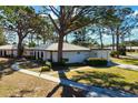 House with a curved walkway, driveway, and surrounding trees at 407 Degas Dr, Nokomis, FL 34275