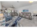 Spacious living room with gray couches and large area rug at 4251 Oak Terrace Cir, Port Charlotte, FL 33953