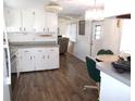 Open kitchen with breakfast nook and view into living room at 426 Boxwood Dr, Venice, FL 34285
