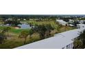 Aerial view showcasing condo community near golf course and pond at 437 Cerromar Ln # 513, Venice, FL 34293