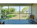 Screened lanai with golf course view and patio furniture at 437 Cerromar Ln # 513, Venice, FL 34293