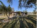 House with a spacious yard and covered patio at 451 Home Park Rd, Venice, FL 34285