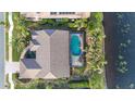 House with pool, landscaping and lake view from above at 4621 Gaeta Dr, Venice, FL 34293