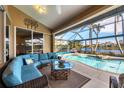 L-shaped sectional sofa and glass coffee table on patio overlooking pool at 4621 Gaeta Dr, Venice, FL 34293