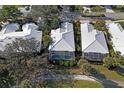 An aerial view of a home with a screened-in pool and lush landscaping at 522 Fallbrook Dr, Venice, FL 34292