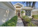 Inviting front entrance with a pathway, well maintained landscape, and a beautiful front door at 522 Fallbrook Dr, Venice, FL 34292