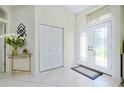 Bright foyer with tile flooring, double-door entry, and decorative accents at 523 Park Estates Sq, Venice, FL 34293