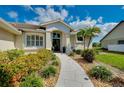Inviting front entrance with landscaped walkway and double doors at 523 Park Estates Sq, Venice, FL 34293