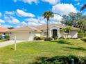 Charming single-story home with tile roof, well-manicured lawn, and landscaping at 523 Park Estates Sq, Venice, FL 34293