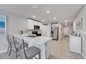 Modern kitchen with white cabinets, stainless steel appliances, and an island at 5550 Eyerly Ter, Port Charlotte, FL 33981