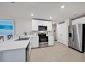 Modern kitchen with white cabinets, stainless steel appliances, and an island at 5550 Eyerly Ter, Port Charlotte, FL 33981