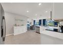 Open concept kitchen with white cabinets and stainless steel appliances at 5550 Eyerly Ter, Port Charlotte, FL 33981