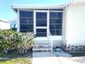 Steps leading to a well-maintained screened porch at 563 Portside Dr, North Port, FL 34287