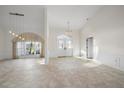 Open living room with tile floors and double doors at 5891 Madison Rd, Venice, FL 34293