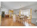 Spacious dining room with hardwood floors, a large table, and a built-in hutch at 740 Citrus Rd, Venice, FL 34293