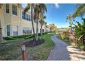 Building exterior showcasing a walkway and lush landscaping at 804 Triano Cir # 804, Venice, FL 34292