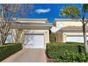 Attached garage with white door and brick paver driveway at 804 Triano Cir # 804, Venice, FL 34292