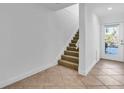 Interior entryway with tiled floors and stairs at 8230 Harborside Cir, Englewood, FL 34224