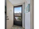 Bright entryway featuring a storm door leading to an open view and charming coastal-themed decor at 854 Bird Bay Way # 190, Venice, FL 34285