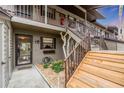 Condo entry with wooden stairs and well-maintained landscaping at 927 Capri Isles Blvd # 7, Venice, FL 34292