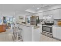 Granite countertop kitchen with stainless steel appliances at 927 Capri Isles Blvd # 7, Venice, FL 34292
