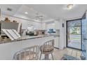 Bright kitchen features granite countertops and white cabinets at 927 Capri Isles Blvd # 7, Venice, FL 34292