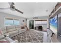 Living room with large sectional sofa, ocean view, and built-in entertainment center at 1000 Tarpon Center Dr # 601, Venice, FL 34285