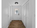 Bright hallway features wood-look flooring, closet space, and a front door with decorative glass at 1023 Hope St, Venice, FL 34285