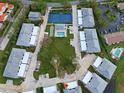 Aerial view of community with tennis court and swimming pool at 1041 Capri Isles Blvd # 119, Venice, FL 34292