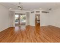 Bright living room with hardwood floors and a view of the outdoor pool area at 1093 Laurel Woods Dr, Nokomis, FL 34275