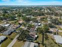 Expansive aerial view showcases the property's location within a community surrounded by mature trees and residential streets at 1212 Mango Ave, Venice, FL 34285