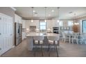 Eat-in kitchen featuring an island with bar stool seating and modern appliances at 13194 Borrego St, Venice, FL 34293