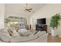 Bright living room boasts tile floors, ceiling fan, and sliding glass doors to a screened lanai at 1537 Monarch Dr, Venice, FL 34293