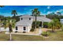 Inviting home exterior with lush lawn, mature palm trees and stone walkway at 15804 29Th E St, Parrish, FL 34219