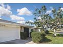 A view of the front exterior showing the garage and stone accent wall at 1600 Lilliput Ct, Venice, FL 34293