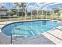 Inviting screened-in pool area with clear blue water and ample patio space for relaxation at 1600 Lilliput Ct, Venice, FL 34293