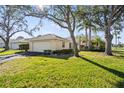 Attractive home featuring an attached garage, lush greenery, and a welcoming entrance at 174 Southampton S Pl # 345, Venice, FL 34293