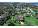 An aerial view showcases the property, a screened-in pool, and beautiful waterfront community at 1773 Hudson St, Englewood, FL 34223