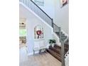 Lovely entryway featuring a staircase with decorative railings, high ceilings, and ample natural light at 19836 Bridgetown Loop, Venice, FL 34293