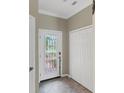 Light and bright entryway with decorative glass front door and tiled floor at 20390 Lagente Cir, Venice, FL 34293