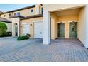 Charming townhome showcasing a beautiful garage and twin front door entry with neutral paint tones at 23194 Banbury Way # 202, Venice, FL 34293