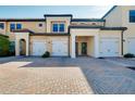 Elegant townhome exterior featuring individual garages and charming curb appeal, perfect for modern living at 23194 Banbury Way # 202, Venice, FL 34293