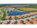 Community aerial showing neighborhood, a lake and pristine landscaping at 24065 Canterwood Way, Venice, FL 34293