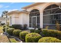 Elegant front entrance featuring a screened porch and decorative landscaping at 3415 N Cranberry Blvd, North Port, FL 34286