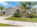 One-story house with light-colored siding, palm trees, and a driveway at 4309 Renwick Dr, Parrish, FL 34219