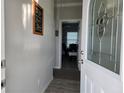 Open entryway featuring light gray walls, decorative signs, and interior views at 530 Walnut Cir, Venice, FL 34285