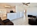 Inviting living room featuring tile floors, neutral walls, and an open layout to the kitchen at 5527 20Th W St, Bradenton, FL 34207