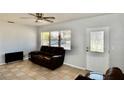 Cozy living room with large window providing natural light, tile flooring, and neutral color scheme at 5527 20Th W St, Bradenton, FL 34207